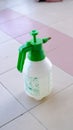 a green and white spray can sitting on a tiled floor Royalty Free Stock Photo