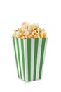 Green white striped carton bucket with tasty cheese popcorn, isolated on white background Royalty Free Stock Photo