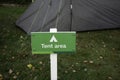 Tent area sign with blurred tent in background