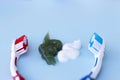 Green and white toothpaste squeezed and toothbrush on blue background Royalty Free Stock Photo