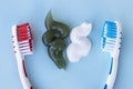 Green and white toothpaste squeezed and toothbrush on blue background Royalty Free Stock Photo
