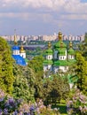 Green and white tops of churches with golden domes and crosses on the background of the bridge and skyscrapers of the Royalty Free Stock Photo