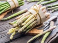 Green and white types of asparagus sprouts on wooden table. Top view