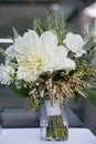 Green and white wedding bouquet in a glass of water - wedding flower series