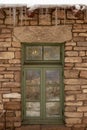 Green Window With Decorative Glass In Stone Wall With Icicles Royalty Free Stock Photo