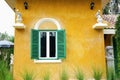 Green window on yellow cement wall . Royalty Free Stock Photo