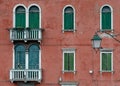 Green windows and earthy red wall