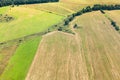 Green winter and yellow harvested fields on hills