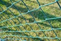 Green wire fence at the football pitch close up view Royalty Free Stock Photo