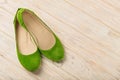 Green women`s shoes ballerinas on wooden background.