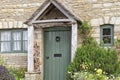 Green wood doors in english traditional stone house Royalty Free Stock Photo