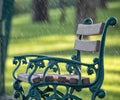 Green wooden bench in a summer park during the rain. Royalty Free Stock Photo