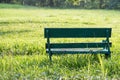 Green Wooden Bench on yard at Rod Fai Park at sunrise, Bangkok Royalty Free Stock Photo