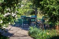 Green wooden chairs and a stone table in the park. A place to relax and socialize. Royalty Free Stock Photo