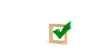 Green wooden checkmark for voting on elections on a white background. Presidency or parliamentary elections, a referendum. Survey