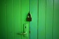 Green wooden door locked by master key Royalty Free Stock Photo