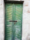 Green wooden door in old house.