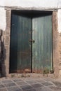 Green wooden door with old lock in Peru. Royalty Free Stock Photo