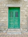 Green wooden door in Patones village, Community of Madrid. Vintage doorway in rural area of Spain