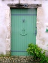 Green wooden door in a seaside village. Royalty Free Stock Photo