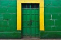 Green wooden door and yellow wall of old house in Trinidad, Cuba Royalty Free Stock Photo