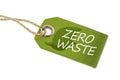 Green wooden hang tag with leafs and the words zero waste