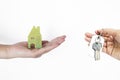 Green wooden house and key in girl hand isolate on white background Royalty Free Stock Photo