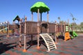 Green wooden house with slider on empty playground. Activity, equipment. Royalty Free Stock Photo