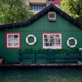 Green wooden house on the water