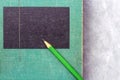 A green wooden pencil is placed on the hardback or textbook. selective focused Royalty Free Stock Photo