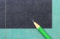 A green wooden pencil is placed on the hardback or textbook. selective focused Royalty Free Stock Photo