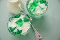 Green woodruff jello with vanilla custard in glass bowls