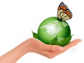 Green world with leaf and butterfly in woman hand.