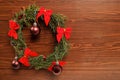 Green xmas wreath with decoration on wooden desk Royalty Free Stock Photo