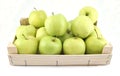 Green and yellow apples in a wooden crate on white background Royalty Free Stock Photo