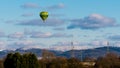 Green yellow balloon flying in blue sky over snowy landscape Royalty Free Stock Photo