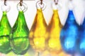 Green, yellow and blue drops-glass transparent earrings hand made, hanging in the store for tourists. Abstract Royalty Free Stock Photo