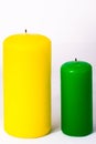 Green and yellow candle on a white background Royalty Free Stock Photo