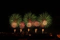 Green and yellow fireworks in a night sky