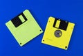 green and yellow floppy disks on a blue background