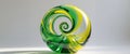 A green and yellow glass sculpture with a spiral shape. Royalty Free Stock Photo