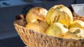 Green yellow grenades in a wicker basket close-up