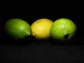 3 Green and yellow lemon on dark background, can be used commercially Royalty Free Stock Photo