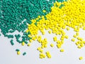 Green and yellow masterbatch granules on white background