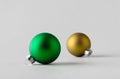 Green and yellow matte Christmas balls on a seamless grey background