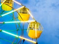 Green and yellow neon sparklers light on Ferris wheel at night c Royalty Free Stock Photo