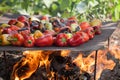 Green and yellow peppers grilling on a BBQ