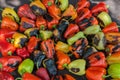 Green and yellow peppers grilling on a BBQ