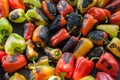 Green and yellow peppers grilling on a BBQ