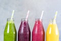 Green, yellow, pink and red smoothie in glass bottles Royalty Free Stock Photo